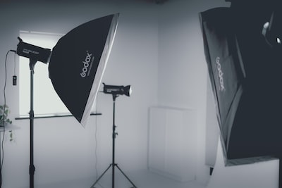Camera on a tripod in a clean white photo studio