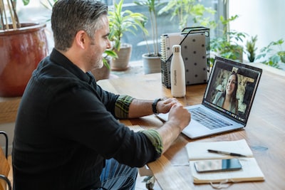 Sales professional managing customer records on a laptop