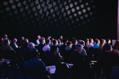 Attendees seated at a packed conference session