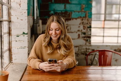 Business owner reading customer feedback on her phone