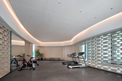 Bright health club floor with treadmills and bikes