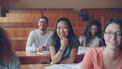 Students smiling in a university lecture hall