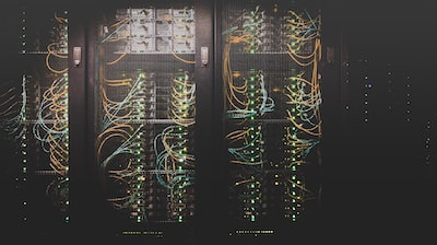 Server racks with network cabling in a dark data centre