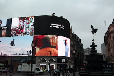 Large digital billboard showing ads above a busy city street corner