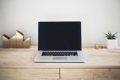 Minimal workspace with a laptop on a clean wooden desk