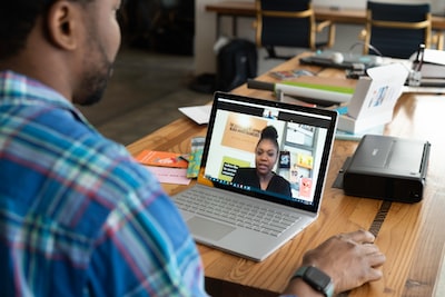 Salesperson on a virtual call with a prospect from his laptop