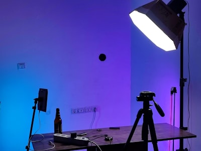 Photo studio with softbox lights and a camera set up around a shooting table