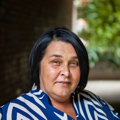 Portrait of a smiling woman in a blue striped top